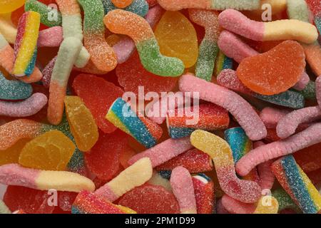 Many different tasty jelly candies as background, top view Stock Photo