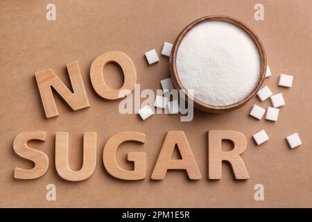Flat lay composition with phrase No Sugar on brown background Stock Photo