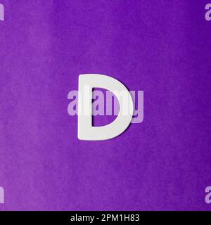 Uppercase letter D - wood texture - Purple background Stock Photo