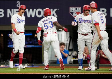 Texas Rangers' Corey Seager, Ezequiel Duran, Marcus Semien, Nathaniel Lowe  and Adolis Garcia, from left, celebrate the team's 4-2 win in a baseball  game against the Philadelphia Phillies, Wednesday, June 22, 2022