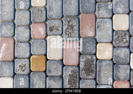 Evenly laid paving stones on the floor on the street in rows. Stock Photo