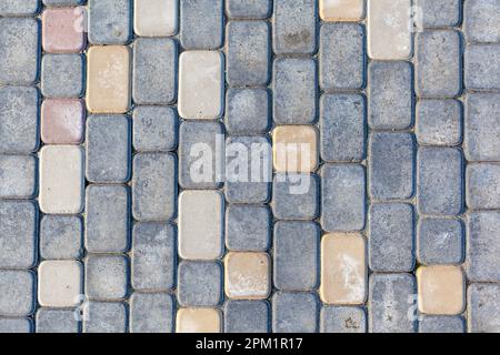 Evenly laid paving stones on the floor on the street in rows. Stock Photo