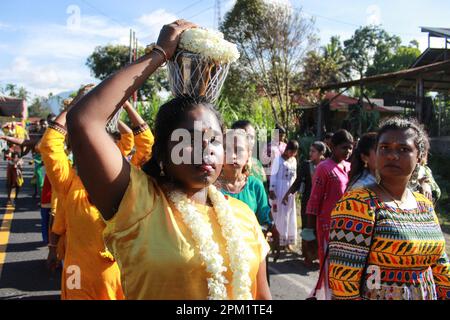 Deliserdang, Indonesia. 09th Mar, 2023. A Hindu woman from the ethnic Tamils, seen with a mouth piercing carrying a jug filled with cow's milk, held high above her head, as she walks towards the Sri Kartigay Sibolangit temple. Ethnic Tamil women, celebrate an annual festival in the month of Pangguni or Pangguni Uthiram to worship the god Muruga. Credit: SOPA Images Limited/Alamy Live News Stock Photo