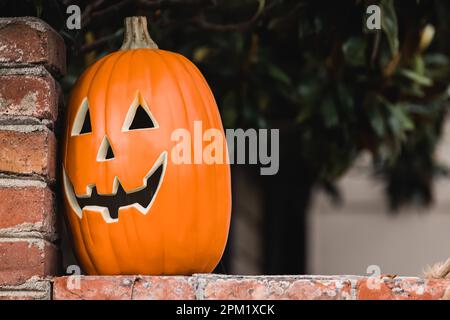 Ceramic decorative Halloween pumpkin outside of the house close-up Stock Photo