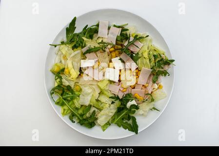 Fresh summer salad with greek feta cheese, rocket, corn and lettuce. Top view Stock Photo