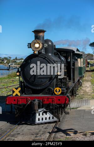 The Cockle Train driven by Engine RX 224, a 1915 built steam locomotive, arrives at Goolwa station in South Australia. Stock Photo