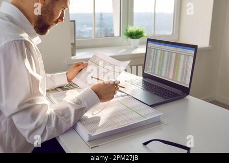 Businessman working at office with laptop and documents Stock Photo