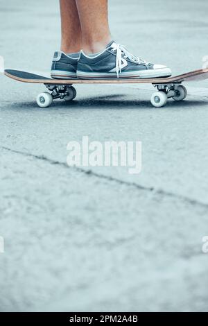 Conceptual photo of active sportive teens. Boy on a skateboard riding on the street. The activity of teenage years. Copy space for text. Stock Photo