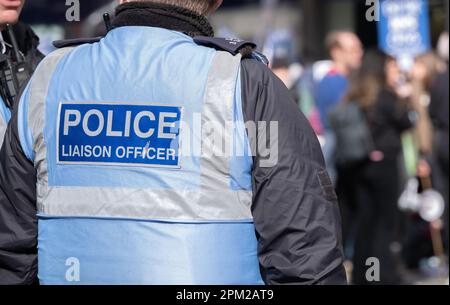 London, UK. 11th March 2023. British Police Liaison Officer monitoring protesters at a demonstration rally in central London, UK. Stock Photo