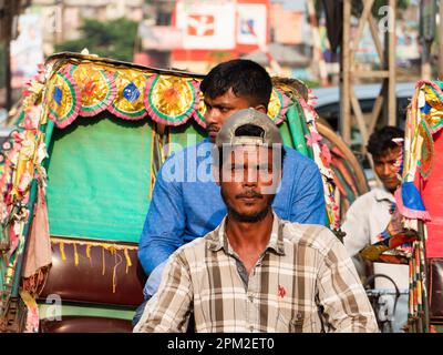 Colourful tricycle taxis in heavy traffic in Dhaka, Bangladesh. Stock Photo