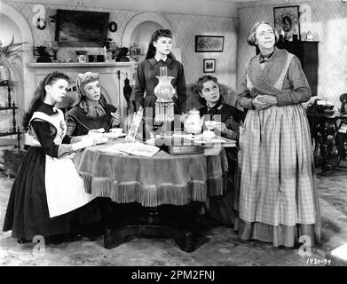 MARGARET O'BRIEN as Beth ELIZABETH TAYLOR as Amy JUNE ALLYSON as Jo JANET LEIGH as Meg and ELIZABETH PATTERSON as Hannah in LITTLE WOMEN 1949 director / producer MERVYN LeROY novel Louis May Alcott costumes Walter Plunkett Metro Goldwyn Mayer (MGM) Stock Photo