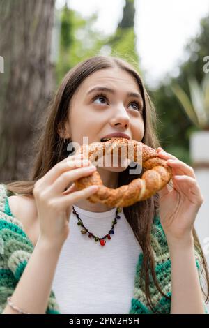 Brunette woman eating traditional turkish simit bread in Istanbul,stock image Stock Photo