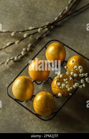 painted golden eggs for easter on green background. High quality photo Stock Photo