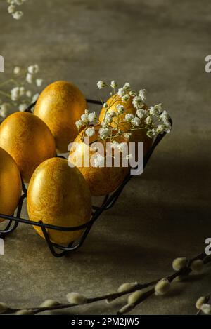 painted golden eggs for easter on green background. High quality photo Stock Photo