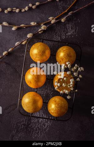 painted golden eggs for easter on black background. High quality photo Stock Photo