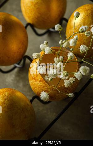 painted golden eggs for easter on green background. High quality photo Stock Photo