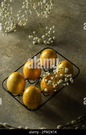 painted golden eggs for easter on green background. High quality photo Stock Photo