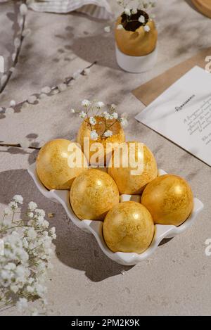 Composition with painted Easter eggs and flowers on white background ...