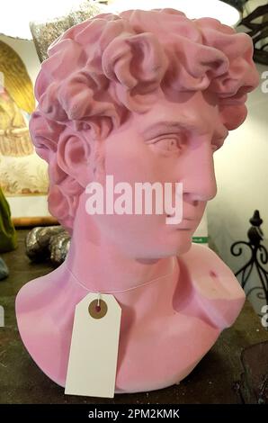 Carving of a young man's head in pink. Stock Photo