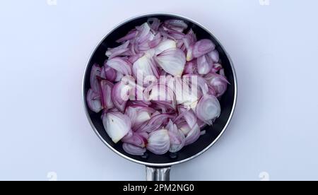 Sliced onions or shallots on frying pan - top view Stock Photo