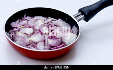 Sliced onions or shallots on frying pan - top view Stock Photo