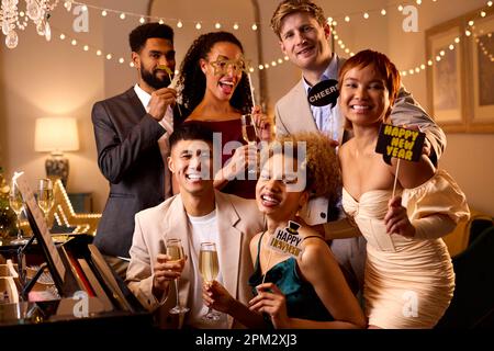 Portrait Of Friends Posing For Selfie Around Piano Celebrating At New Year Party Together Stock Photo