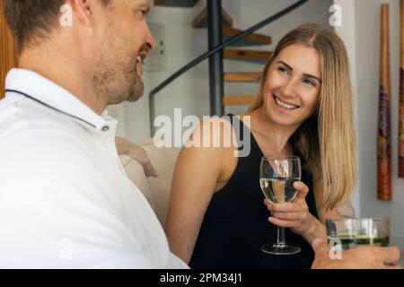 smiling young couple dating and drinking wine at home Stock Photo