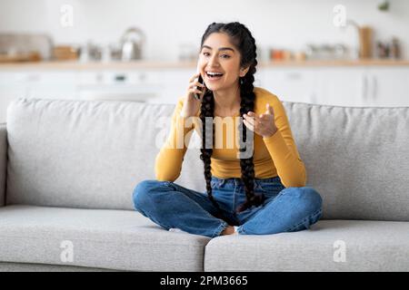 Mobile Communication. Beautiful Indian Woman Talking On Cellphone At Home Stock Photo