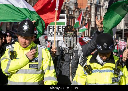 Protest by supporters of Palestine outside the embassy of Israel in Kensington, London, UK, protesting about the actions of Israel. Marching Stock Photo