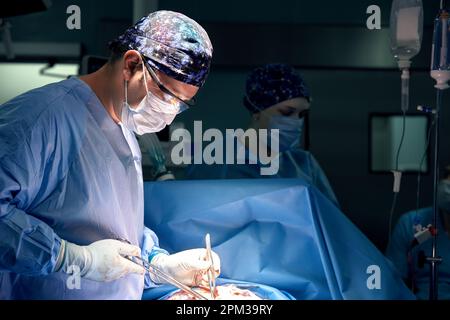 A team of surgeons in the oncological operating room, the fight against ancology, the hard work of professional doctors, the operation of the sarcoma Stock Photo