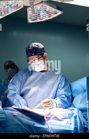 A team of surgeons in the oncological operating room, the fight against ancology, the hard work of professional doctors, the operation of the sarcoma Stock Photo