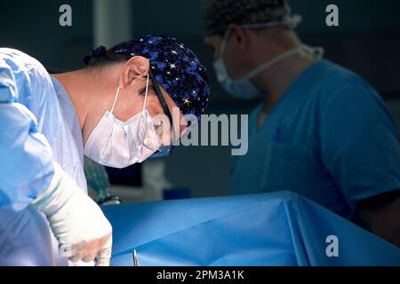 A team of surgeons in the oncological operating room, the fight against ancology, the hard work of professional doctors, the operation of the sarcoma Stock Photo