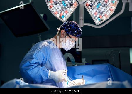 A team of surgeons in the oncological operating room, the fight against ancology, the hard work of professional doctors, the operation of the sarcoma Stock Photo