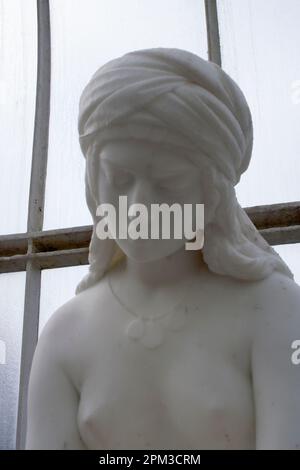 Sculpture of The Nubian Slave by Italian sculptor, Antonio Rossetti, around 1850 within the Kibble Palace in the Glasgow Botanic Gardens, Glasgow, Sco Stock Photo