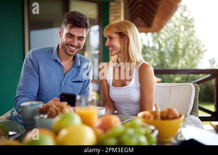 Young couple enjoying on terrace Stock Photo