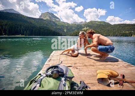 Man and girl Enjoying Near lake.Young couple in love Stock Photo