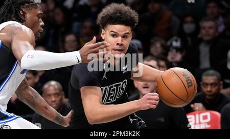 Brooklyn Nets forward Cameron Johnson (2) drives to the basket against  Cleveland Cavaliers guard Donovan Mitchell (45) during the second half of  an NBA basketball game, Thursday, March 23, 2023, in New