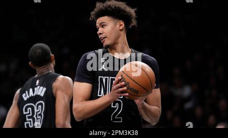 Brooklyn Nets forward Cameron Johnson, left, drives against Detroit Pistons  guard Jared Rhoden (8) during the first half of an NBA basketball game  Wednesday, April 5, 2023, in Detroit. (AP Photo/Duane Burleson