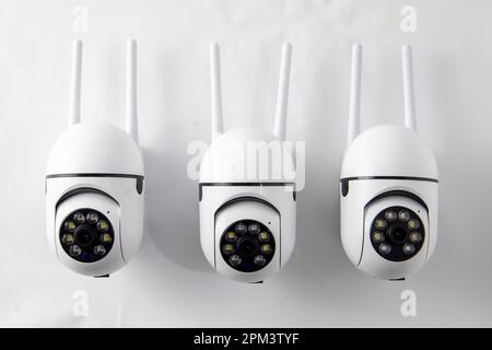 Rotating video surveillance camera on a white background. Stock Photo