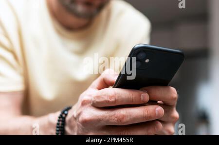 Male person using his cellphone closeup photography. Stock Photo