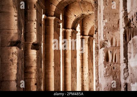 El Jem, Tunisia, January 10, 2023: Portico with columns and buttresses in the side area of the large Roman amphitheater at El Jem Stock Photo