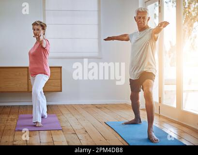 Staying active in their old age. a senior couple doing yoga together. Stock Photo