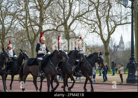 Members of the Blues and Royals cavalry regiment on horseback ride along The Mall, London, England, UK Stock Photo