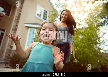 Shes always ready for some outdoor fun with Mom. a mother bonding with her adorable little daughter outside. Stock Photo