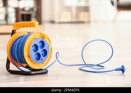 Extension electric cable reel on floor Stock Photo