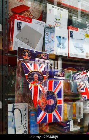 Tonbridge, Kent April 11th, 2023. Cheap Union Jack flags, bunting and other commemorative memorabilia for the upcoming Coronation of King Charles III for sale outside a hardware store. King Charles III will be crowned alongside Camilla, the Queen Consort, on Saturday 6 May 2023 at Westminster Abbey in London. Stock Photo