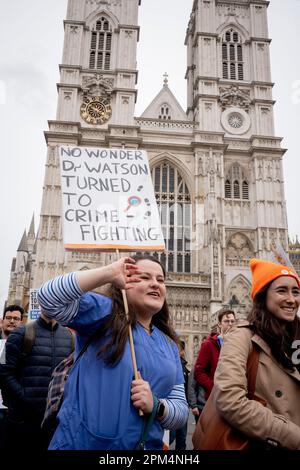 On the first of their four-day nationwide industrial action, striking junior doctors march past Westminster Abbey, on 11th April 2023, in London, England. The walkout by members of the British Medical Association are staging the first of a four-day stoppage in pursuit of a 35% pay rise. Stock Photo