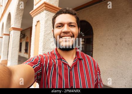 POV Latin american adult young man taking a selfie. Stock Photo