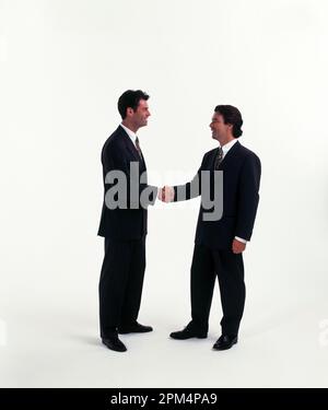 Business executives. Two young men shaking hands. Stock Photo