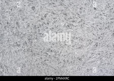 Ice on frozen river forming crystal like structures, closeup macro detail from above - abstract winter background Stock Photo